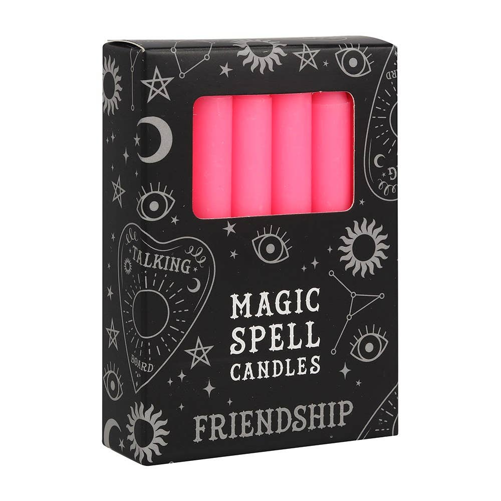 Box of pink 'Magic Spell Candles' with 'Friendship' text on a black background with white designs.