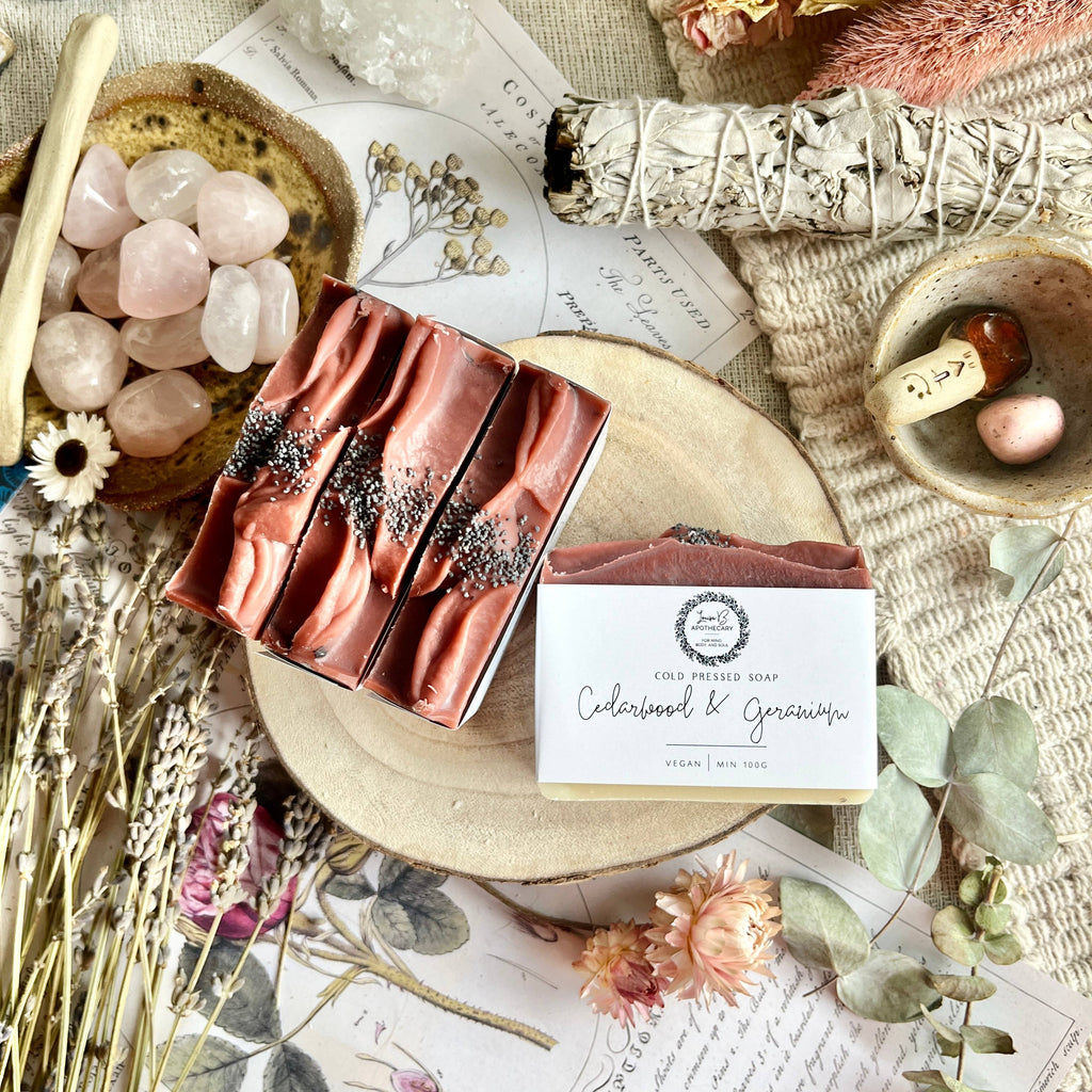 Two soap bars with decorative elements on a textured surface