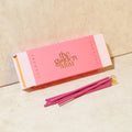 Pink incense box with 'the golden altar' branding and pink incense sticks on a beige background