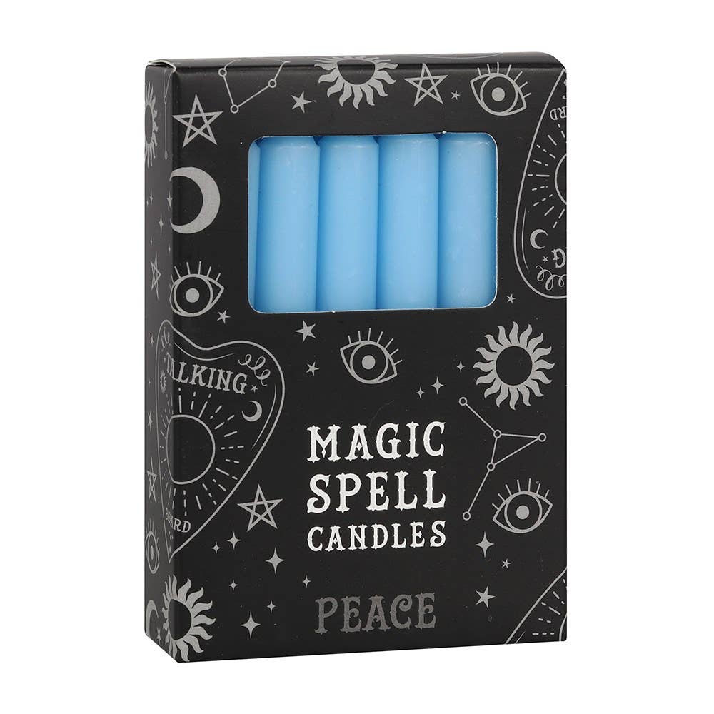 Box of blue spell candles with mystical designs on the packaging